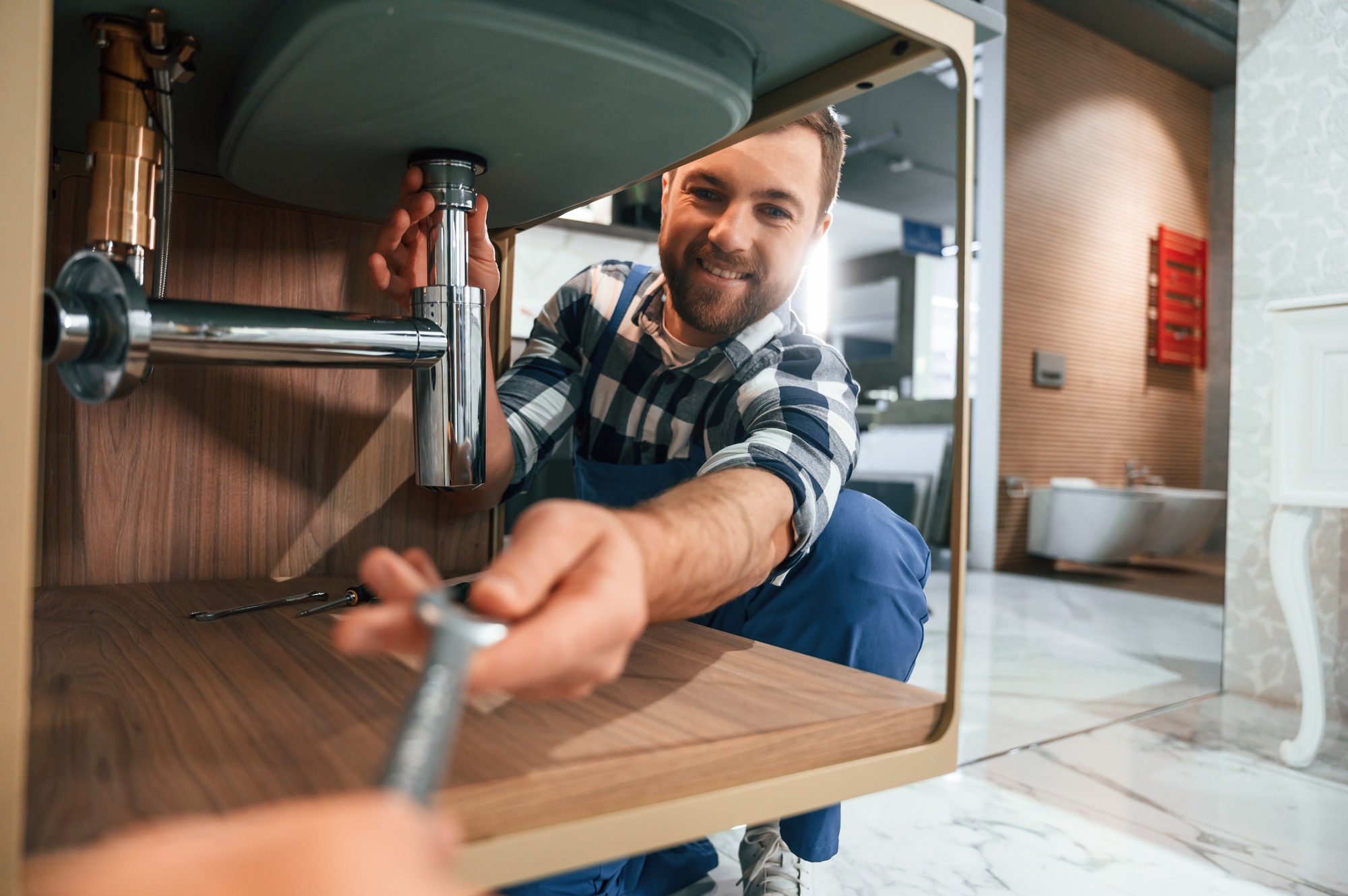 Spangler Plumbing technician repairing pipes in a Delaware home